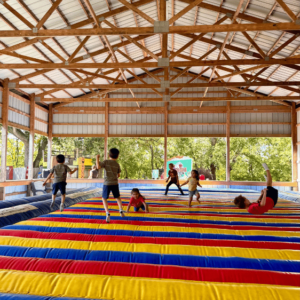 Kids jumping on a large jump pad