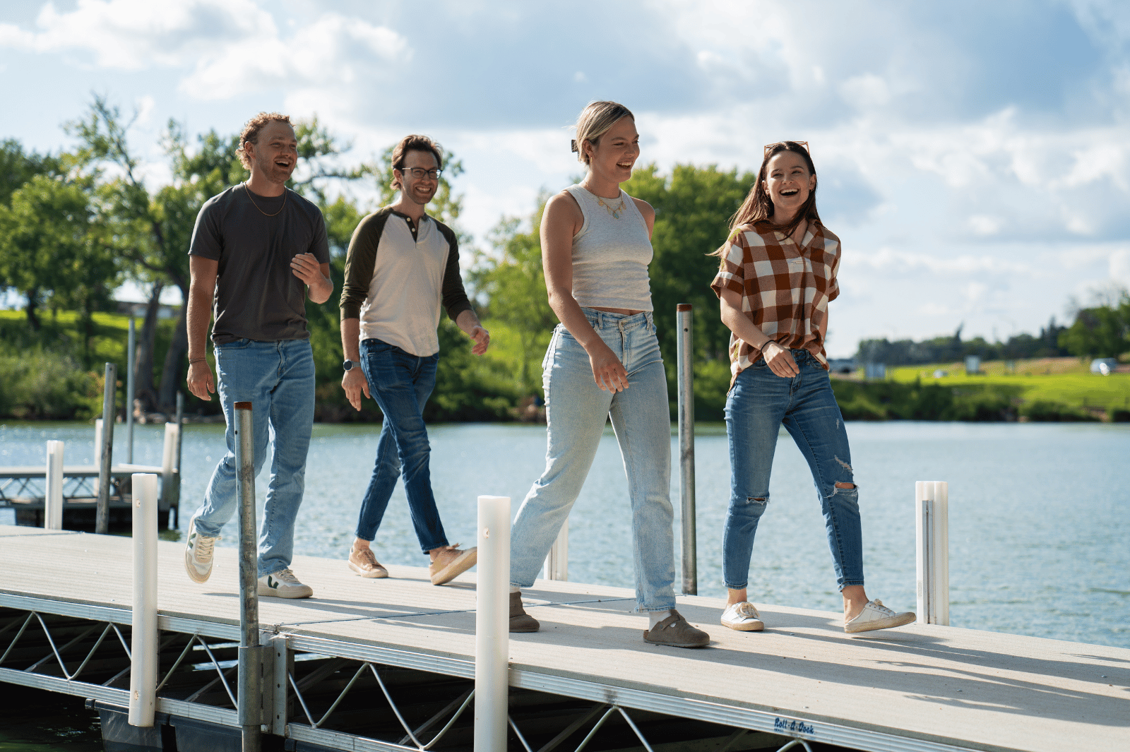 Fairmont, Minnesota. Image for homepage. Group of friends walking on a dock on Fairmonts chain of lakes