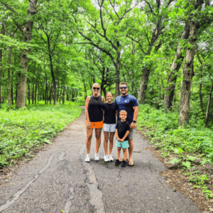 Family posing on a trail at Cedar Creek Park