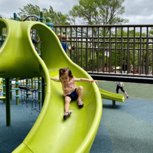 Child on a slide at Gomsrud park at the accessible playground