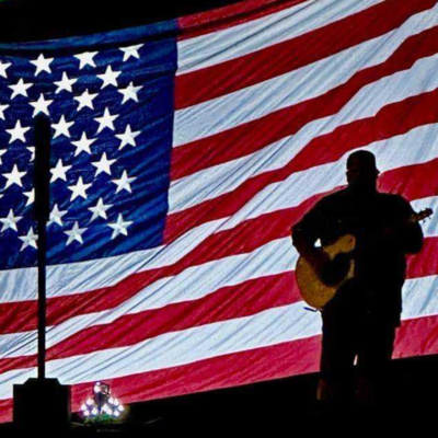 Canaan James in front of American Flag