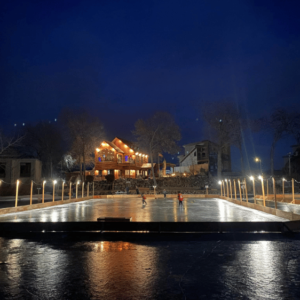 View of hockey tournament at night with the marina lodge in the background