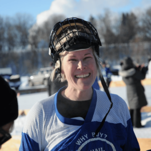 Southern Minnesota Pond Hockey Particpant smiling in hockey gear