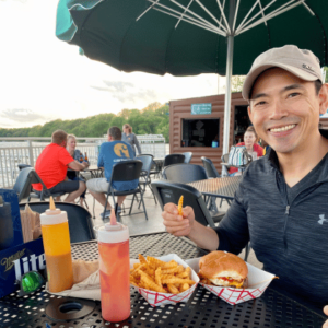 Guest eating at a lakeside dining restaurant at the Channel Inn on Fairmont's Chain of Lakes in Southern Minnesota