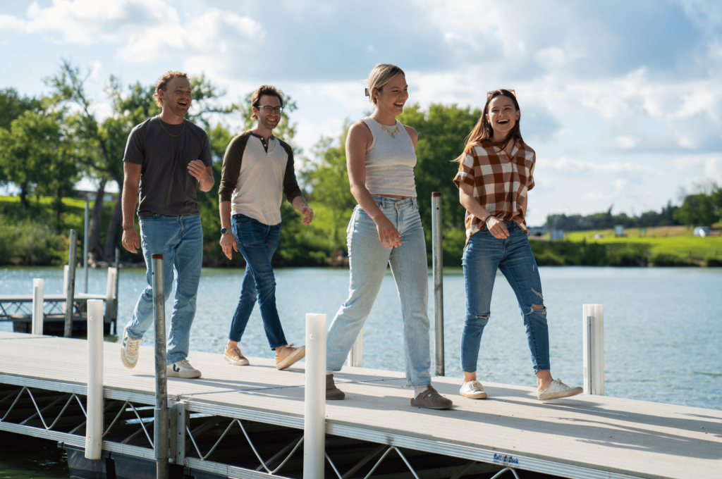 Friends walking on a dock on Fairmont's Chain of Lakes located in Southern Minnesota