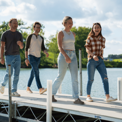 Friends walking on a dock on Fairmont's Chain of Lakes located in Southern Minnesota