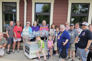 The happy pig collectors club posing in front of a pig statue in Fairmont Minnesota