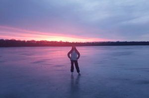 Girl Ice Skating on Fairmont's Chain of Lakes in Southern Minnesota during sunset