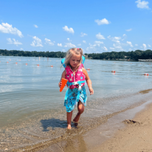 Child swiming in Fairmont's Chain of Lakes at Gomsrud Park's Swimming Beach