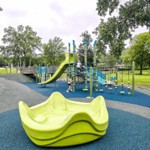 Kids playing on the accessible playground at Gomsrud Park in Fairmont, Minnesota
