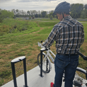 Man checking out a bike at the Free Fairmont Bike Share Program located near the mini golf course and the Fairmont Aquatic Park in Fairmont, Minnesota