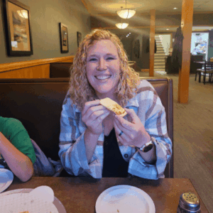A women eating pizza at Jake's Pizza in downtown Fairmont
