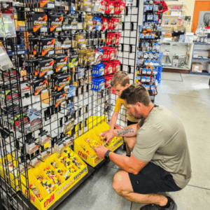 Father and son browsing bait and tackle inside Sommer Outdoors in Fairmont, MN.