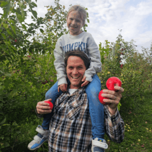 Family at Timberlake Orchard near Fairmont, Minnesota picking apples